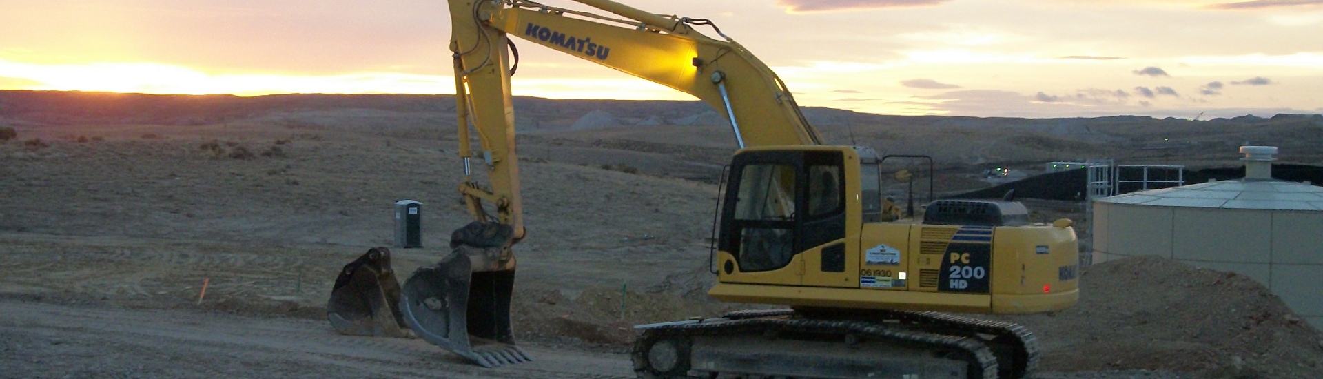 backhoe working at sunset